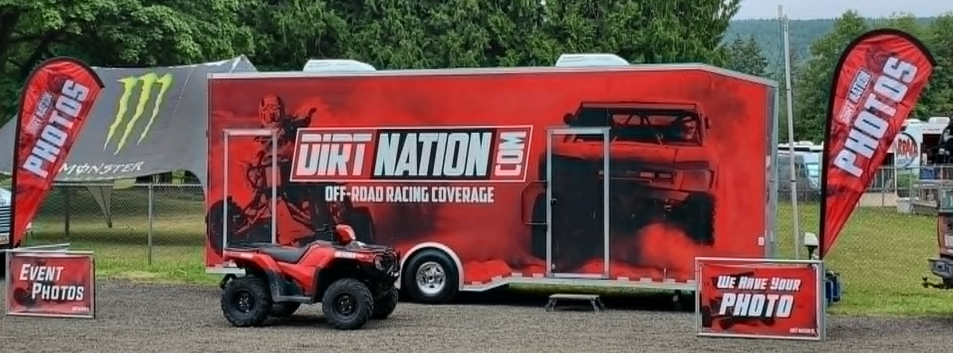 Dirt Nation event trailer trackside with photo flags